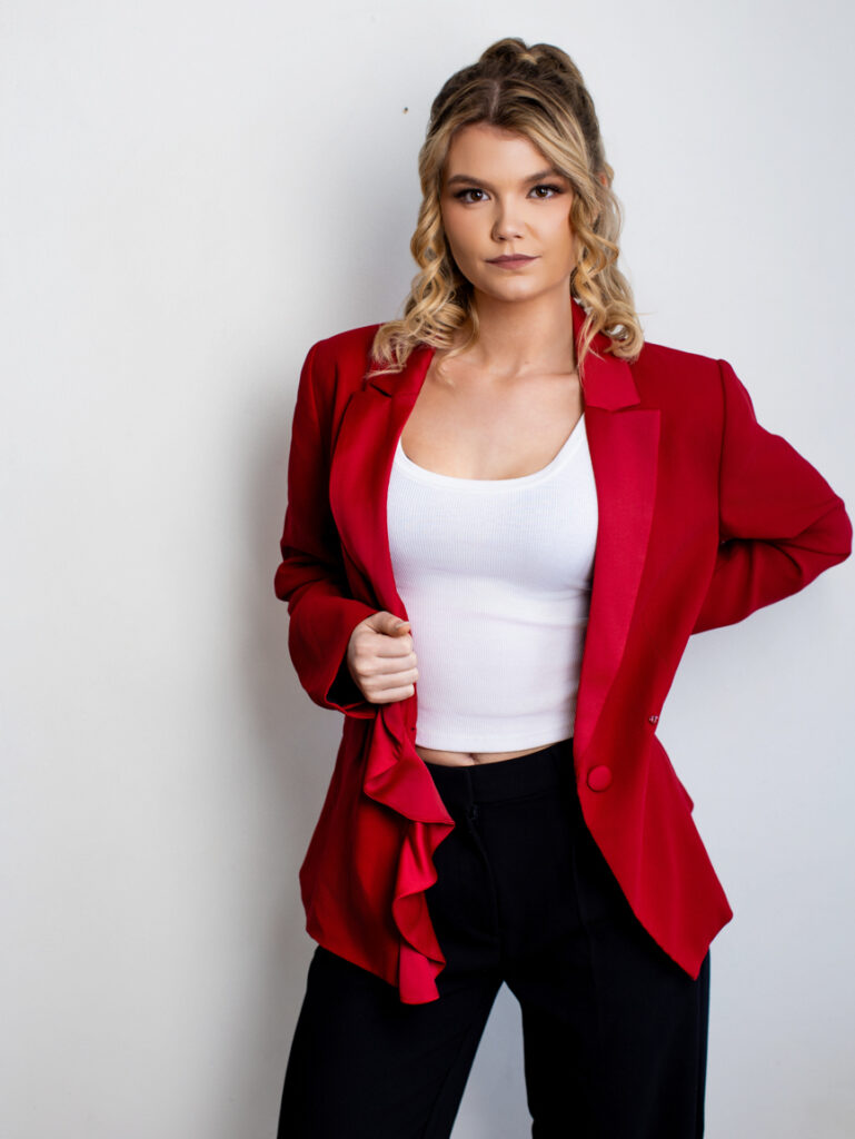 Studio branding shot of a woman entrepreneur showing a confident, direct gaze.